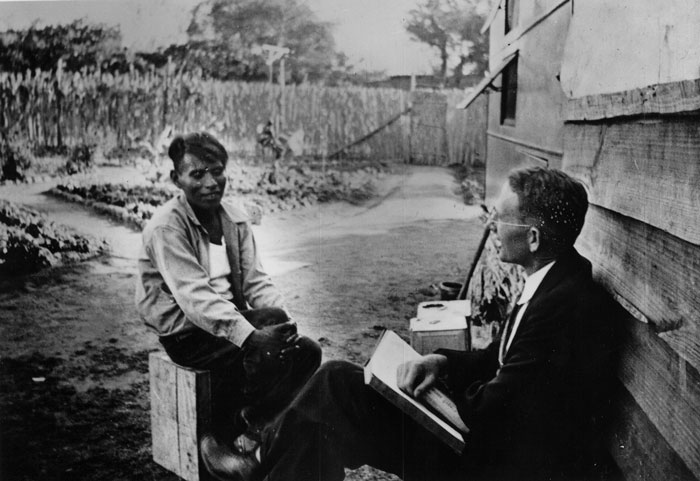 Cameron Townsend in Tetelcingo, Morales Mexico, 1936, studying the Aztec language with a young Aztec man